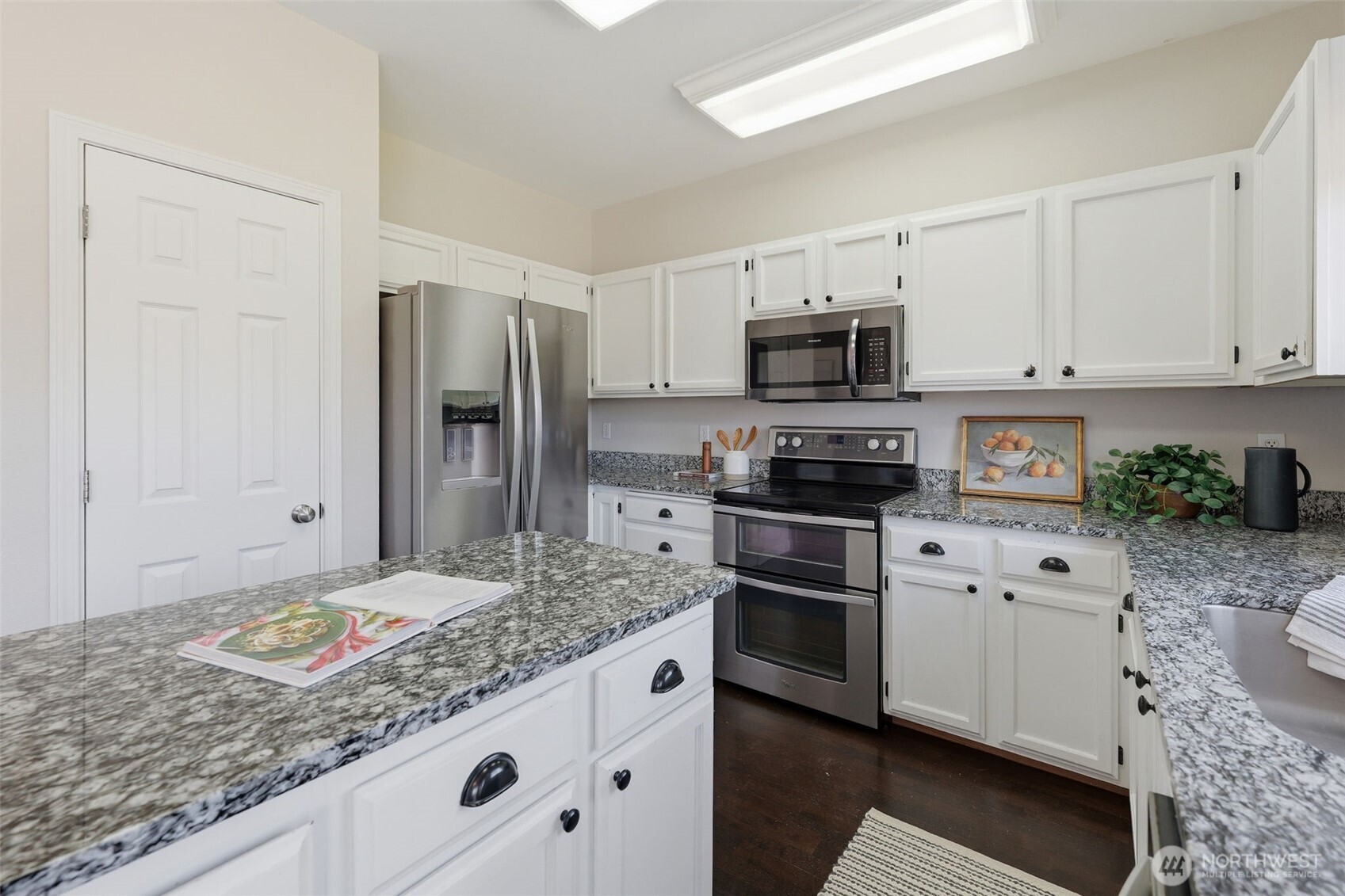 7625 148th Avenue East Sumner, WA 98390 - Photo 13 of 40 a kitchen with granite countertop a refrigerator sink and stove