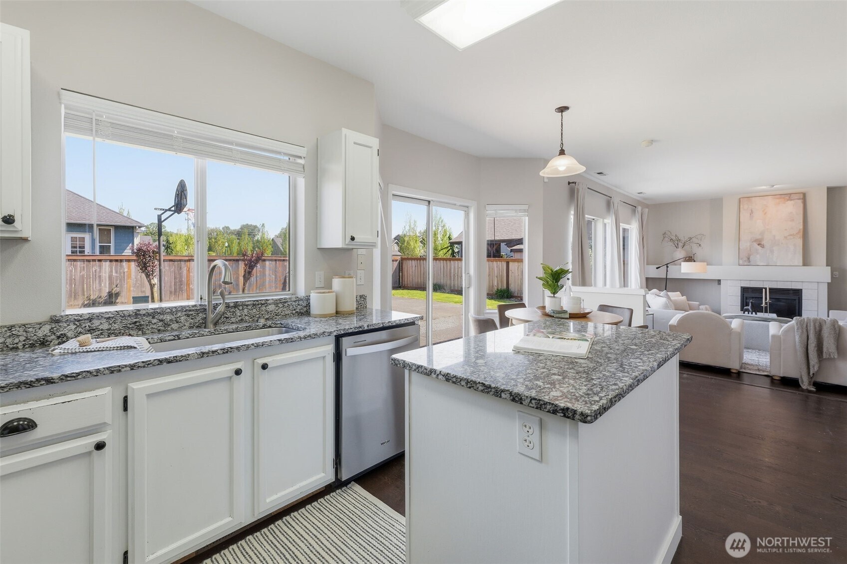 7625 148th Avenue East Sumner, WA 98390 - Photo 16 of 40 a kitchen with granite countertop kitchen island a sink and a stove