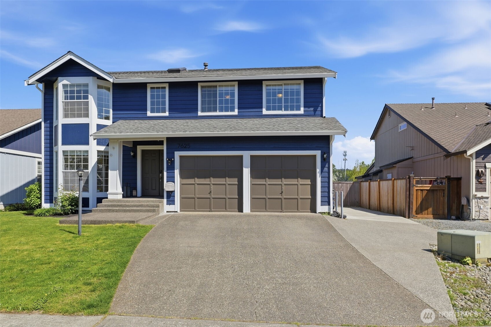 7625 148th Avenue East Sumner, WA 98390 - Photo 2 of 40 a front view of a house with yard and green space