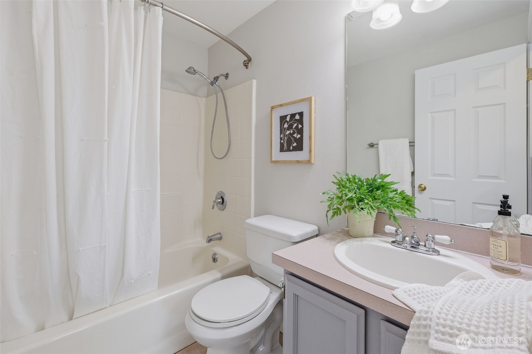 7625 148th Avenue East Sumner, WA 98390 - Photo 24 of 40 a bathroom with a sink toilet a mirror and shower