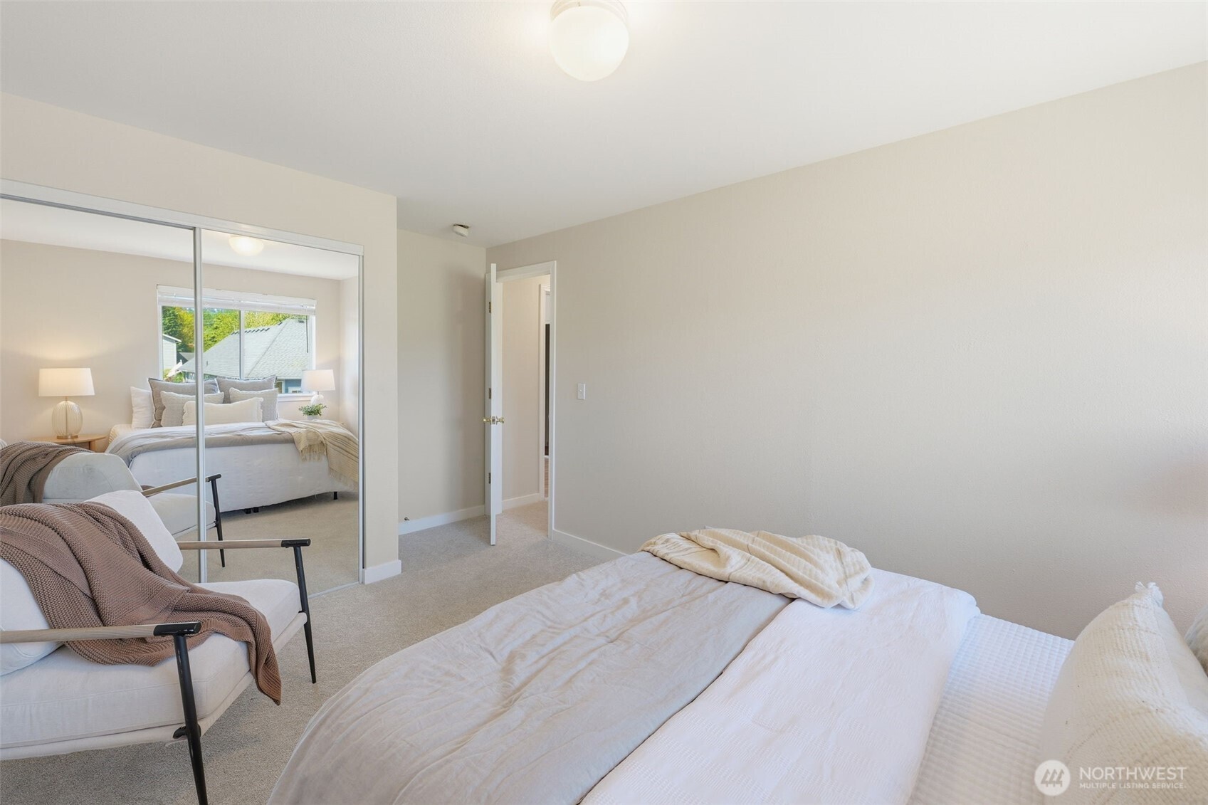 7625 148th Avenue East Sumner, WA 98390 - Photo 30 of 40 a bedroom with a bed and a couch