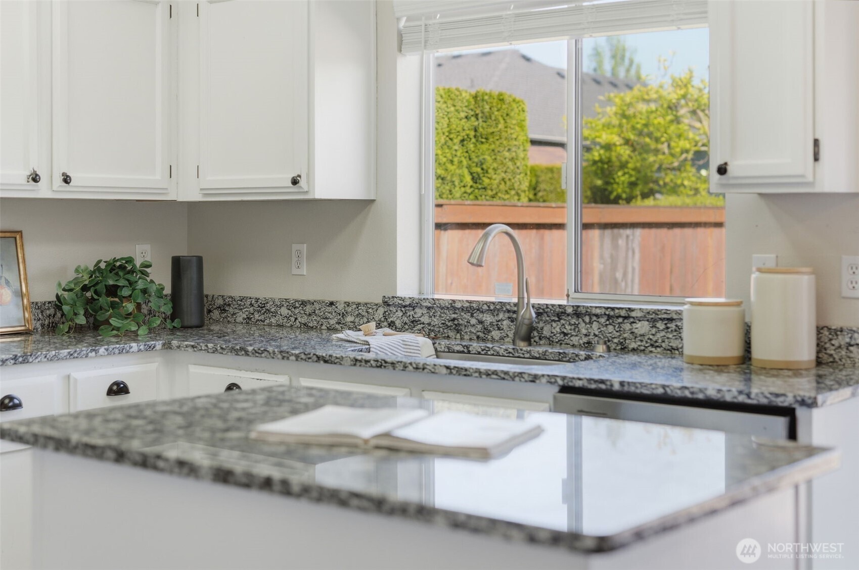 7625 148th Avenue East Sumner, WA 98390 - Photo 32 of 40 a kitchen with granite countertop a sink and a white appliances