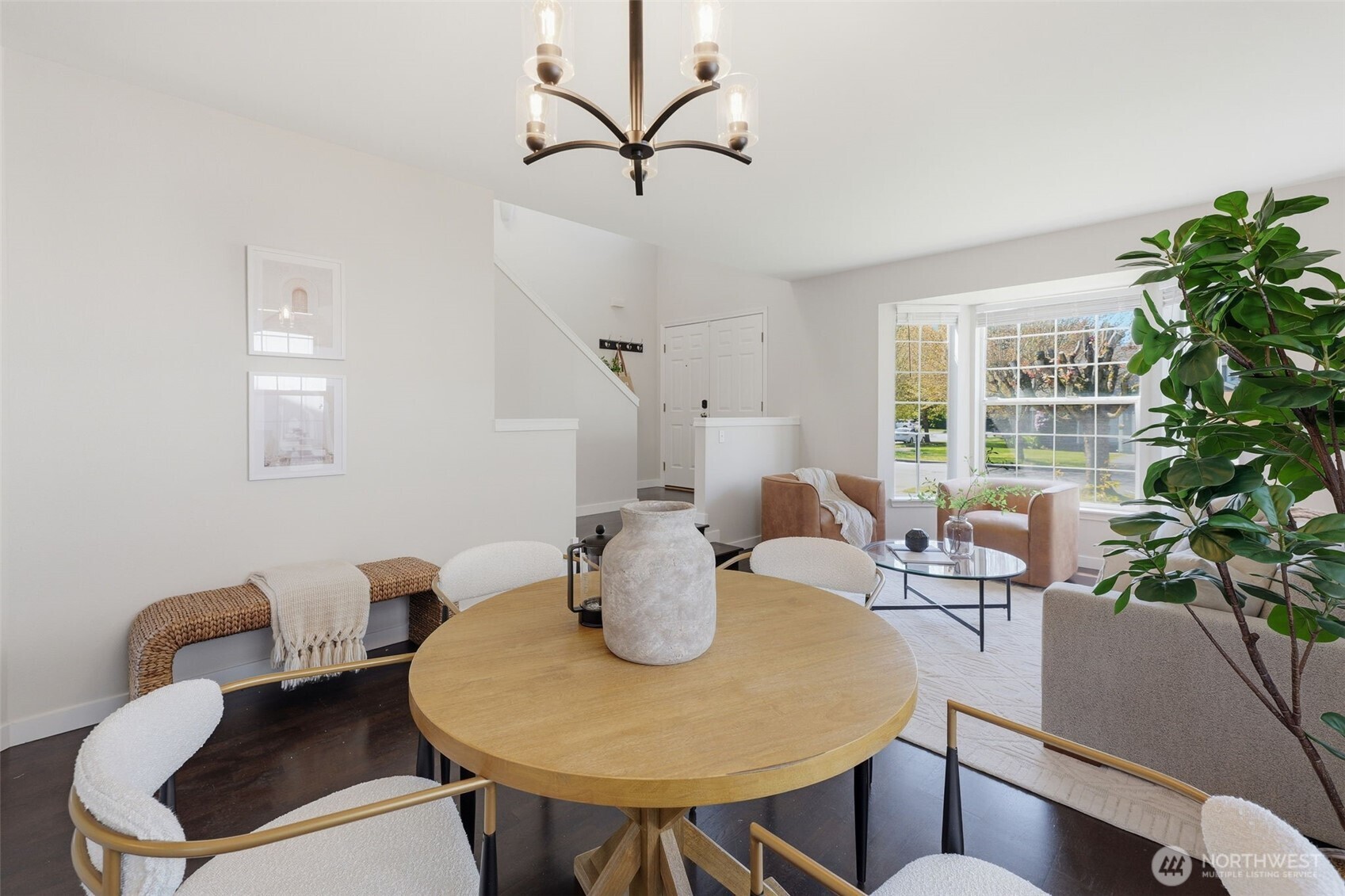 7625 148th Avenue East Sumner, WA 98390 - Photo 10 of 40 a view of a dining room with furniture and a potted plant