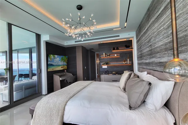 a bedroom with a bed and a chandelier