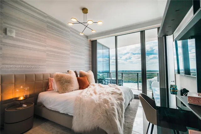 a bedroom with a large bed and a balcony view