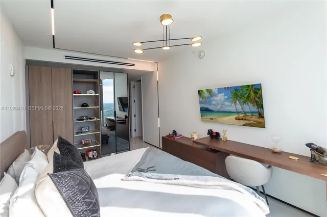 a bed room with a bed and a television