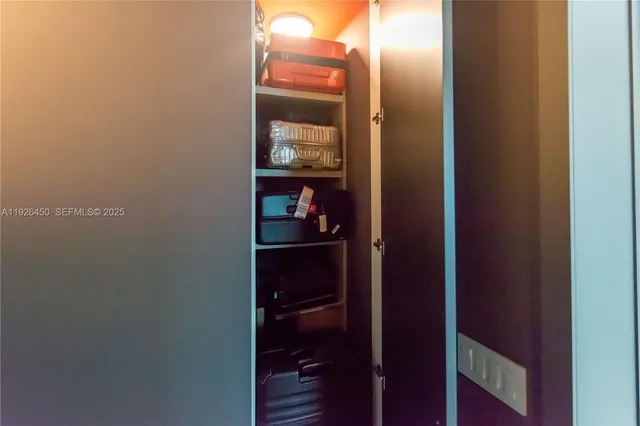 a bathroom with a sink mirror toilet and next to a window