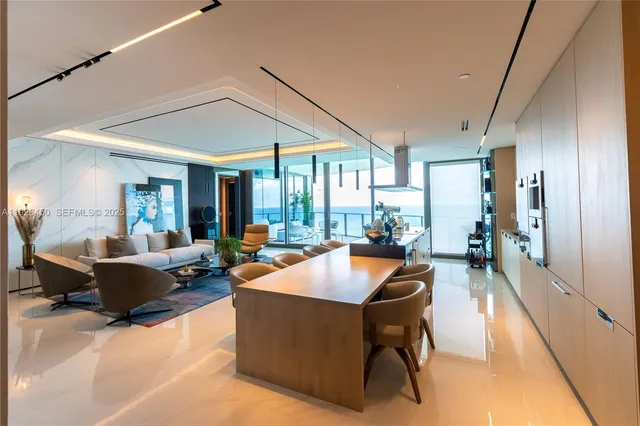 a living room with furniture a couch and a chandelier