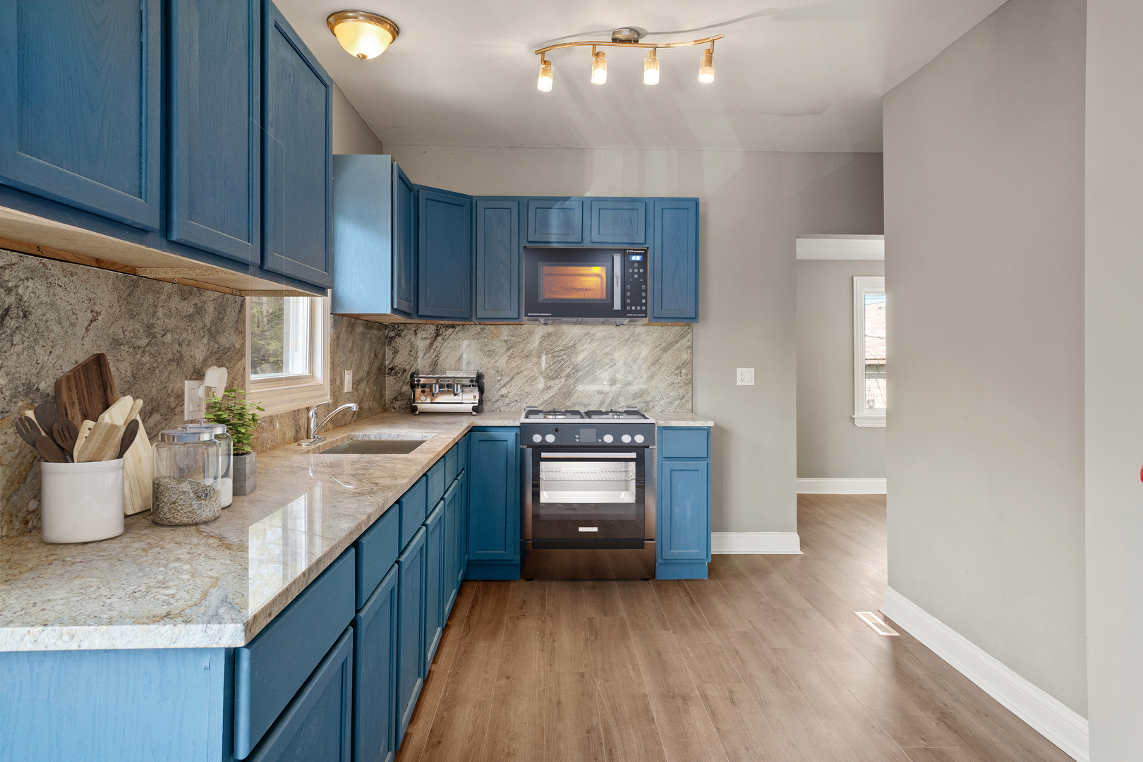 Undisclosed Address Dolton, IL 60419 - Photo 7 of 17 a kitchen with stainless steel appliances granite countertop a sink stove and wooden cabinets