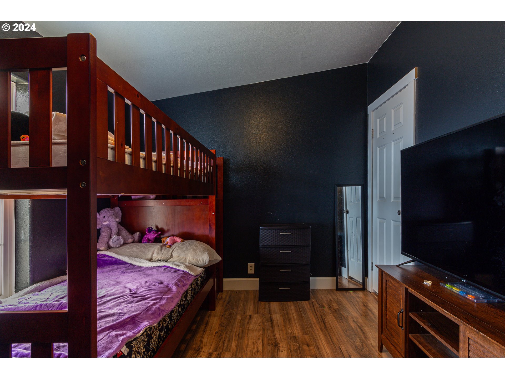 80265 Canal Road Hermiston, OR 97838 - Photo 13 of 26 a bedroom with a bed and a flat tv screen on dresser