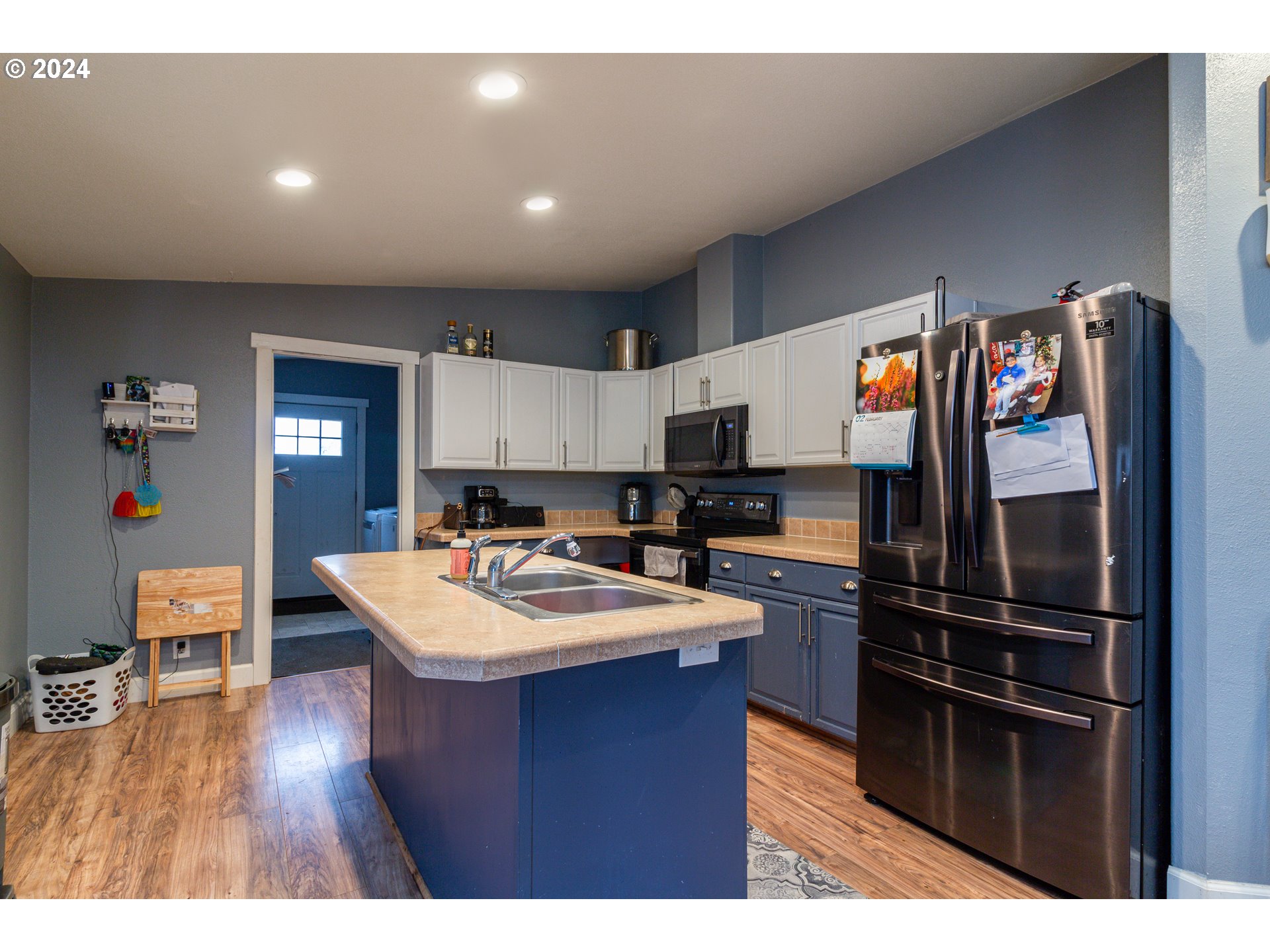 80265 Canal Road Hermiston, OR 97838 - Photo 2 of 26 a kitchen with a refrigerator and a wooden floor