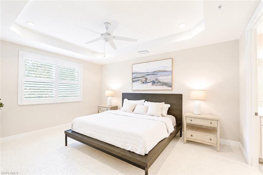 2620 Seychelles Circle, Unit 1302 Naples, FL 34112 - Photo 15 of 43 a bedroom with a bed and a painting on the wall