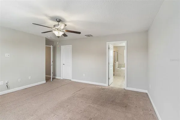 a view of an empty room with a fan