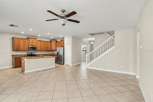 a view of kitchen with granite countertop a stove top oven a sink and a counter top space