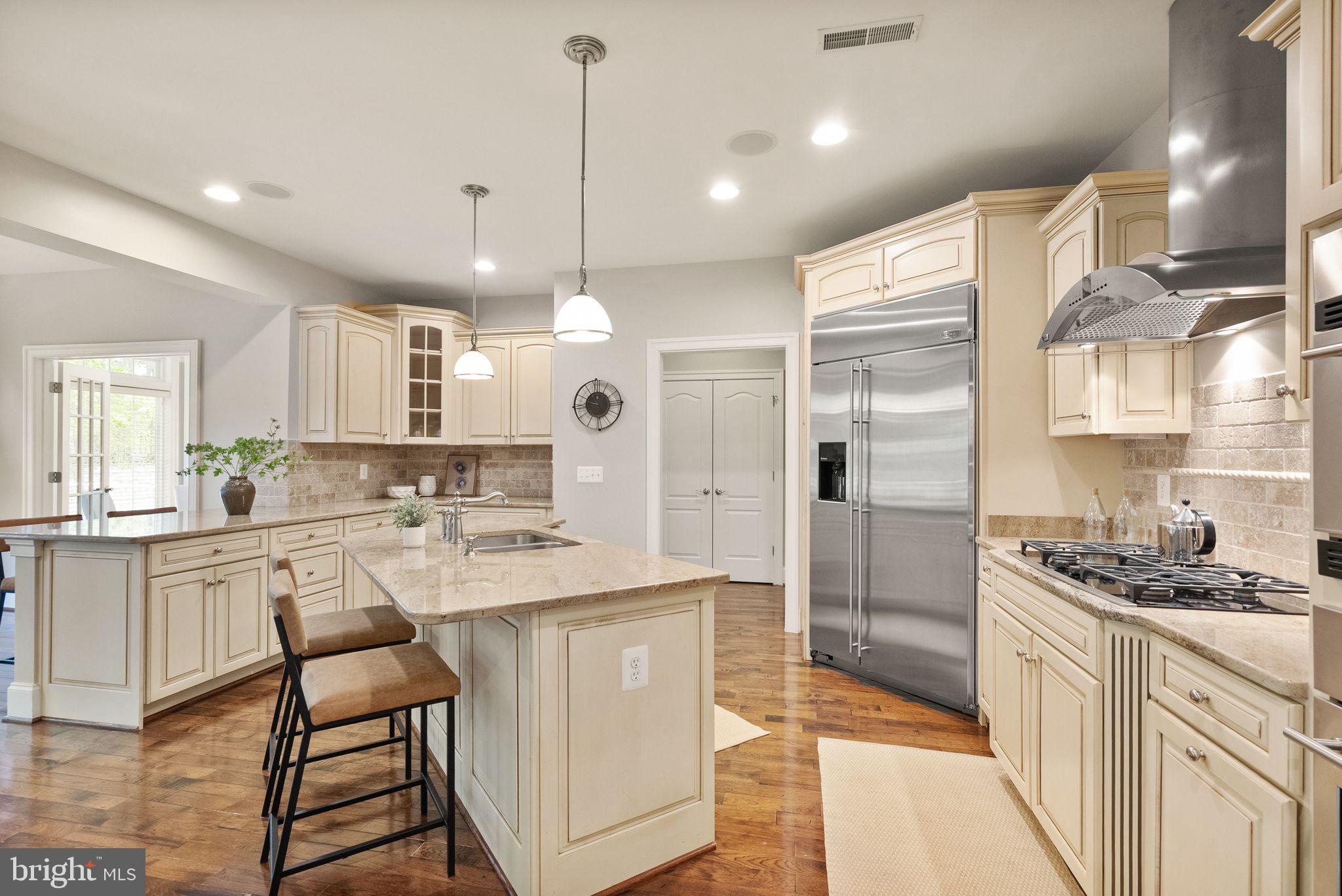 7534 Red Hill Drive Springfield, VA 22153 - Photo 17 of 90 a large kitchen with kitchen island a refrigerator a stove a sink dishwasher with a dining table and chairs