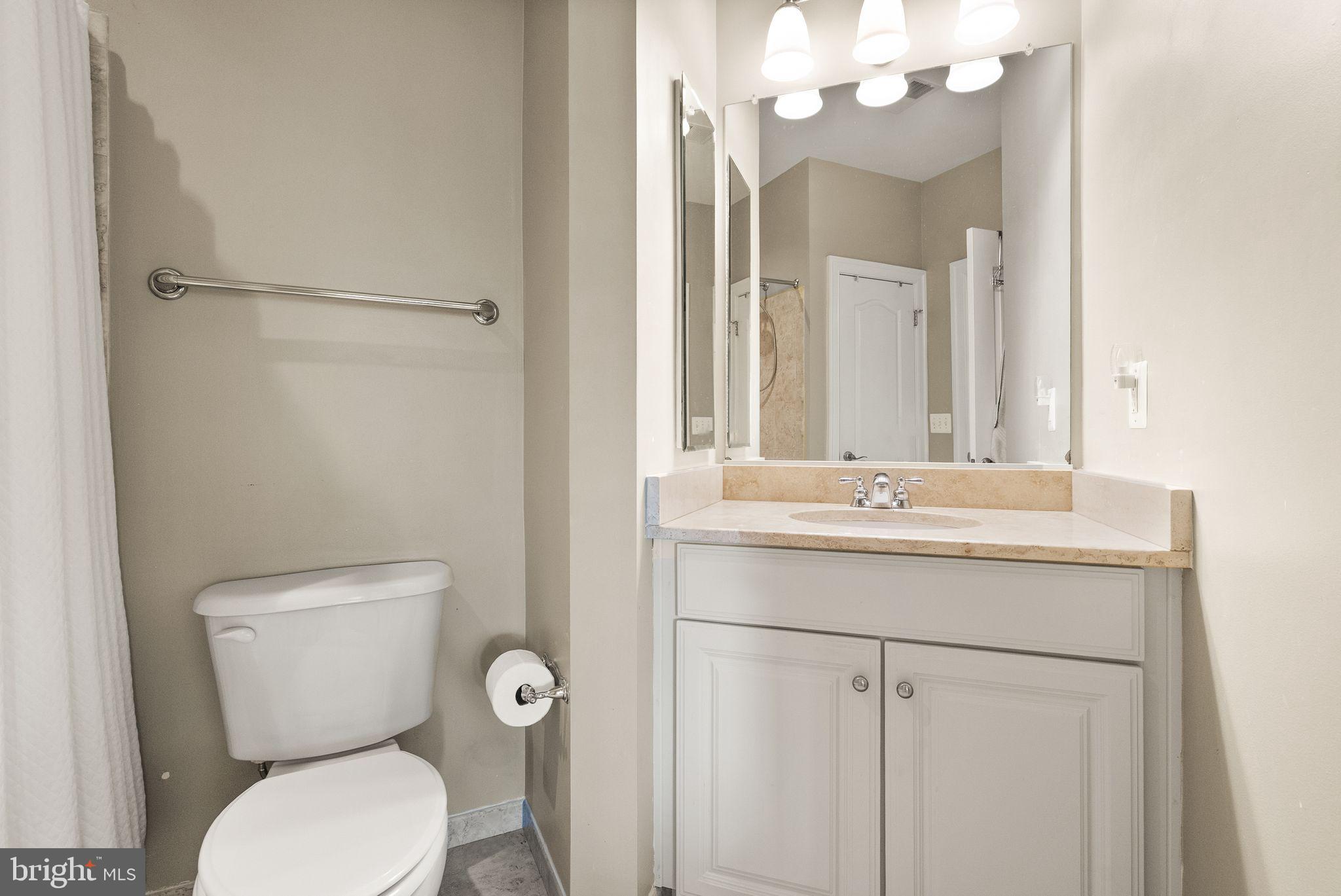7534 Red Hill Drive Springfield, VA 22153 - Photo 51 of 90 a bathroom with a toilet sink and mirror