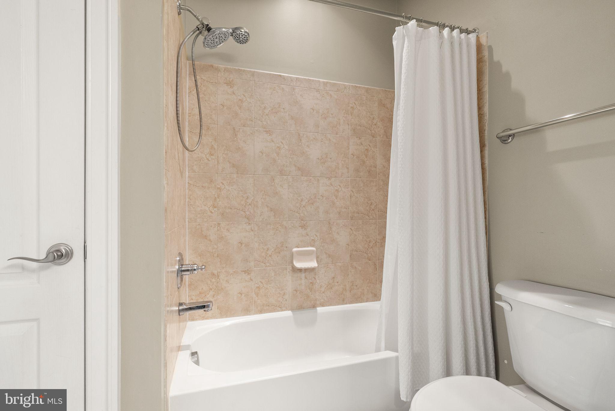7534 Red Hill Drive Springfield, VA 22153 - Photo 52 of 90 a bathroom with a bathtub and a shower