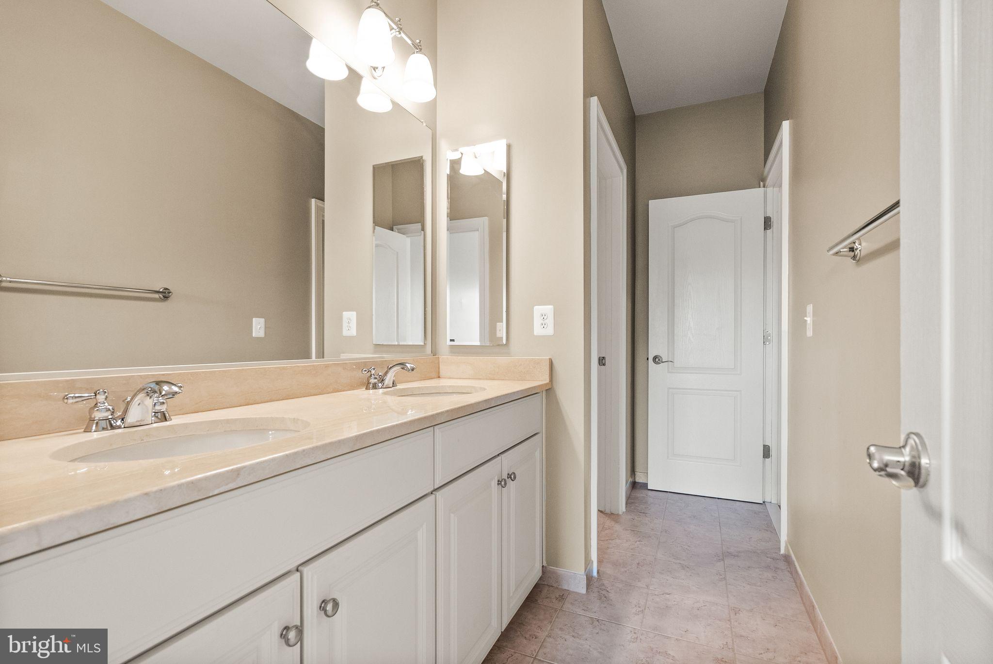 7534 Red Hill Drive Springfield, VA 22153 - Photo 58 of 90 a bathroom with a double vanity sink and a mirror