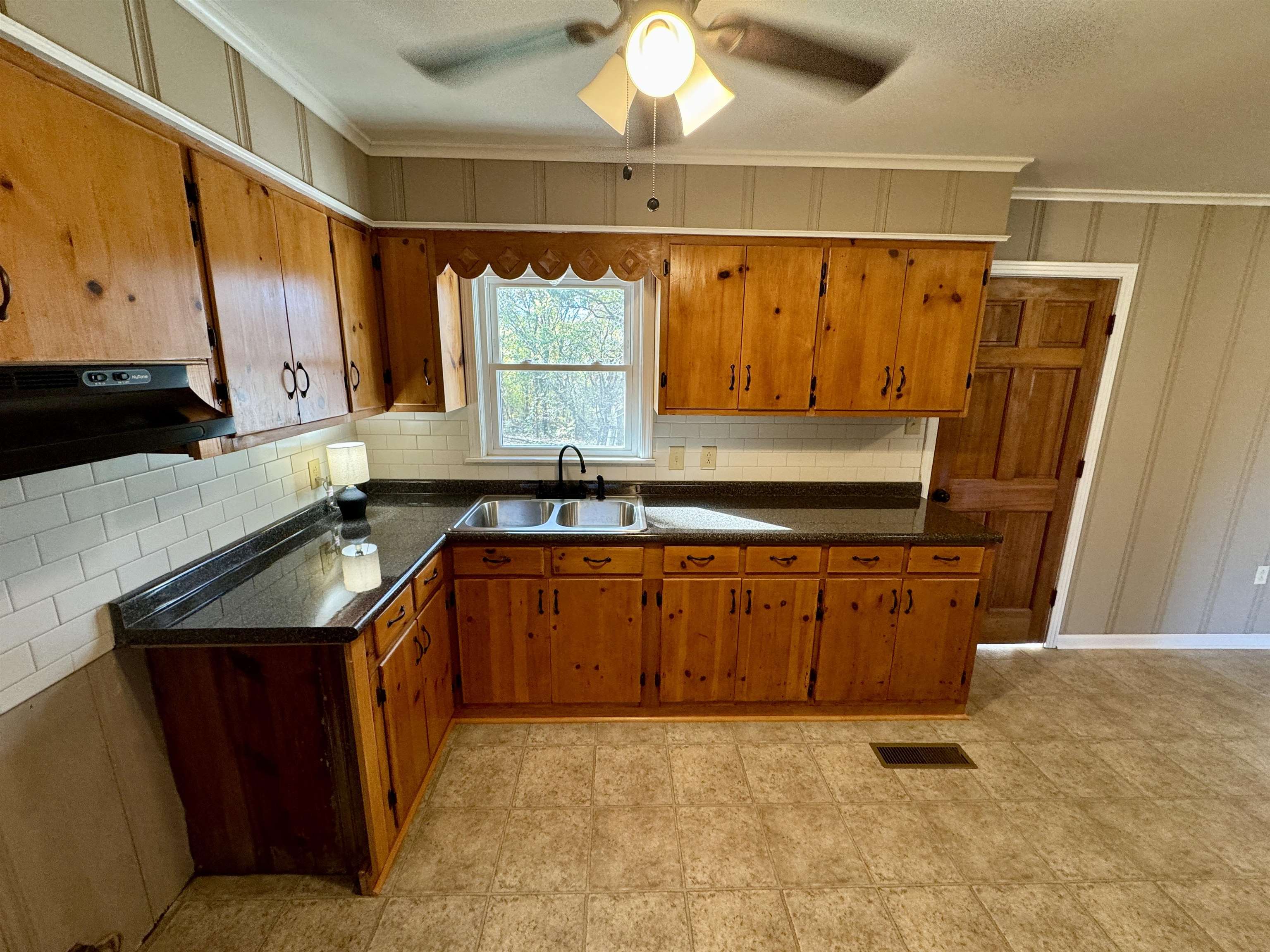 35 Ellis Loop Ripley, TN 38063 - Photo 11 of 18 a kitchen with stainless steel appliances granite countertop a sink a stove cabinets and wooden floor
