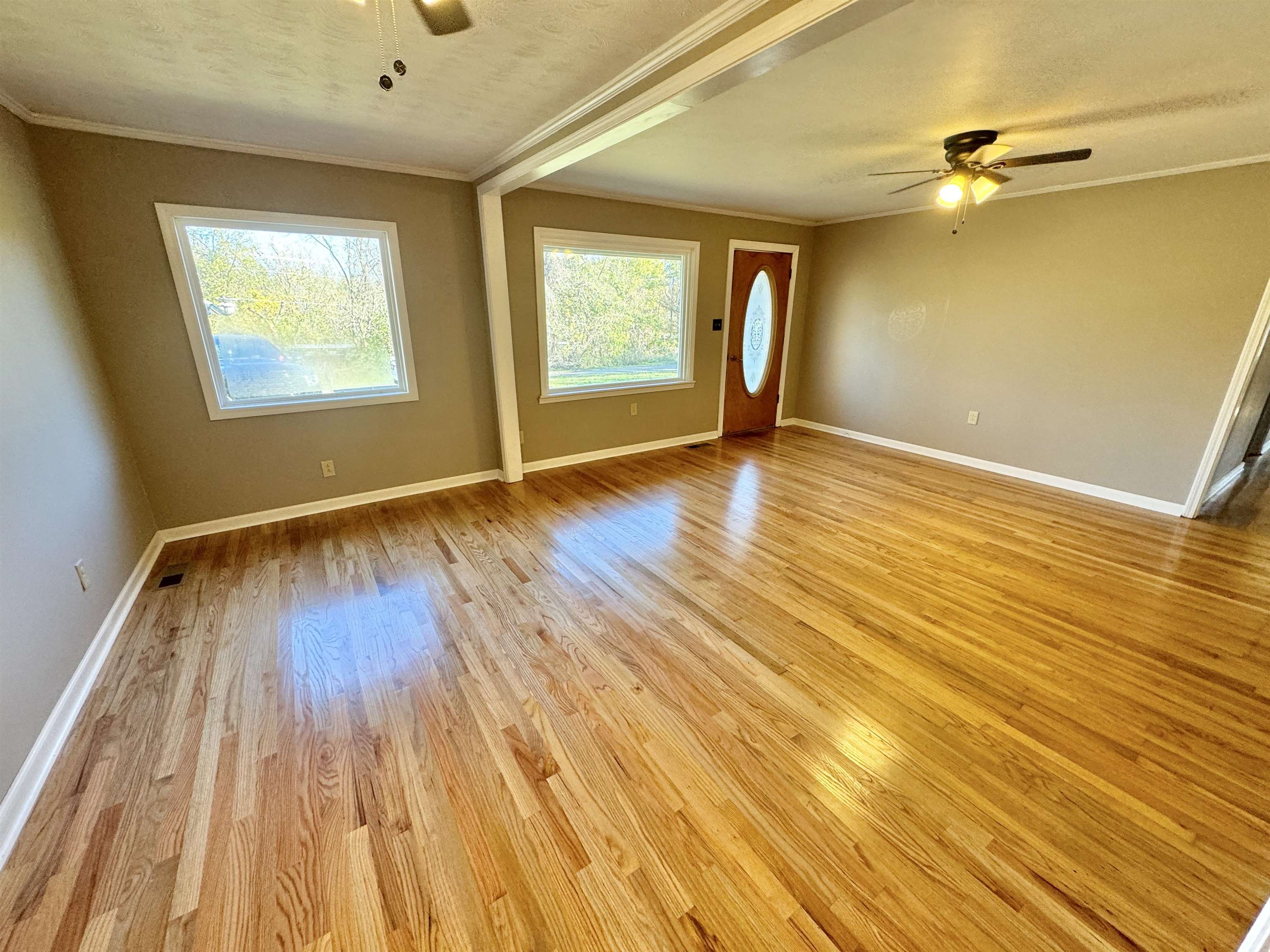 35 Ellis Loop Ripley, TN 38063 - Photo 2 of 18 an empty room with wooden floor and windows