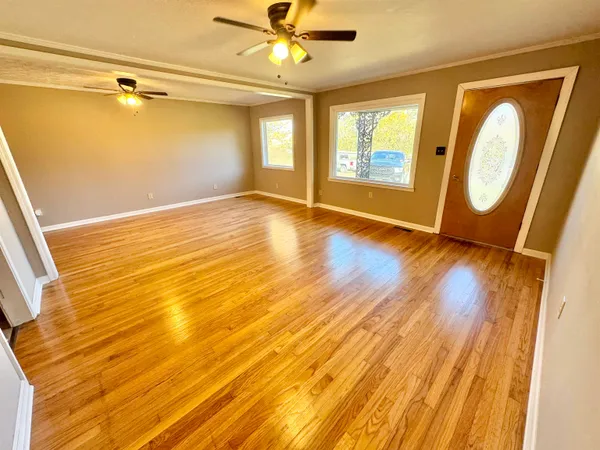 a view of a room with wooden floor and natural light