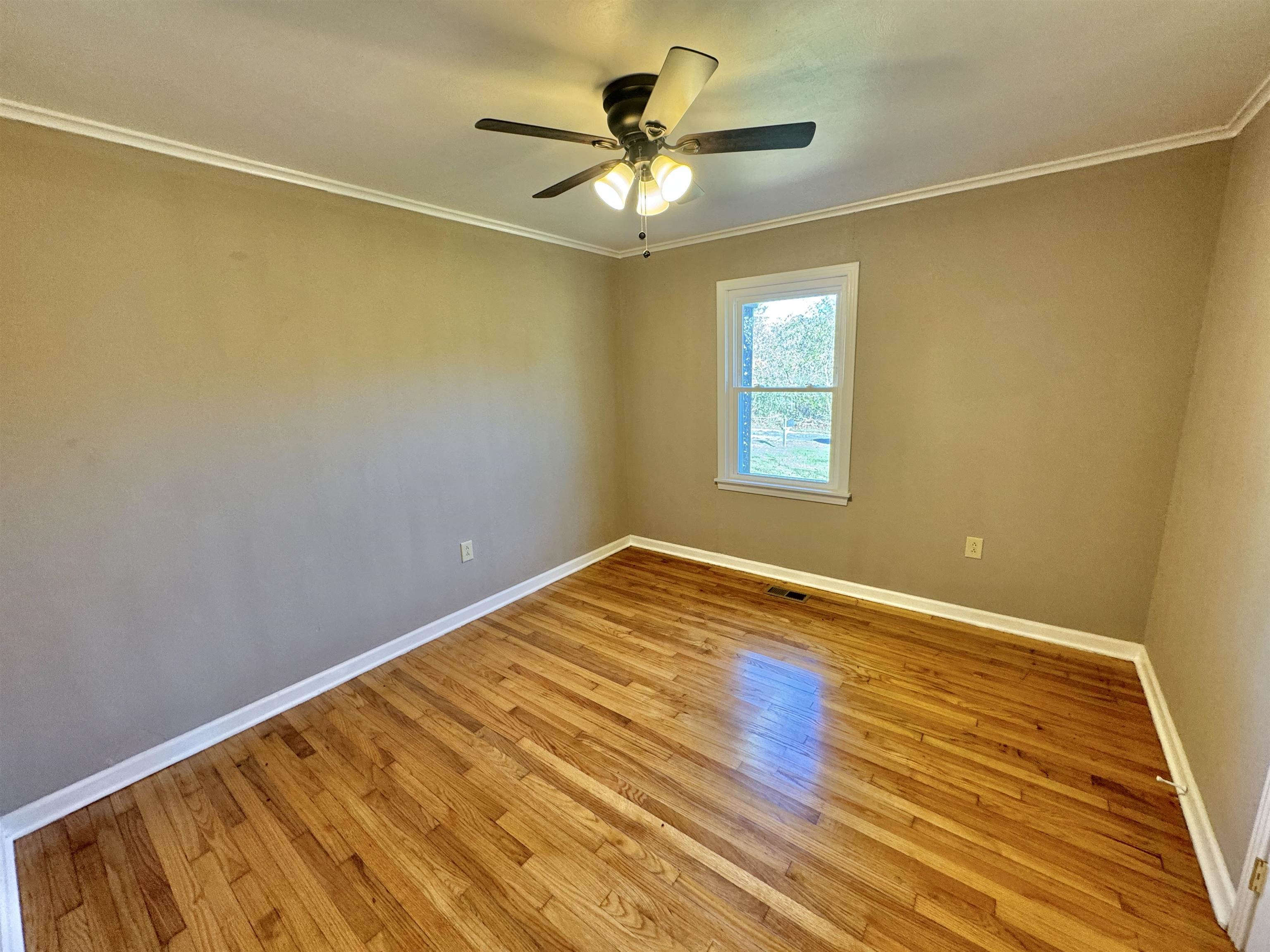35 Ellis Loop Ripley, TN 38063 - Photo 6 of 18 a view of empty room with wooden floor and fan