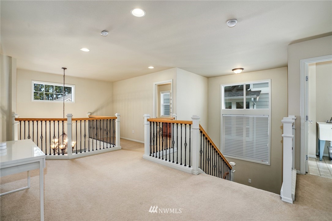 4113 Northeast 27th Place Renton, WA 98059 - Photo 17 of 27 a view of a hallway with bedroom and windows