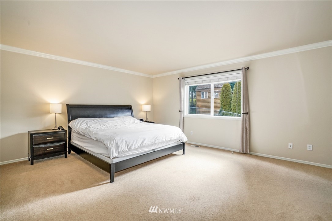 4113 Northeast 27th Place Renton, WA 98059 - Photo 18 of 27 a bedroom with a bed and window