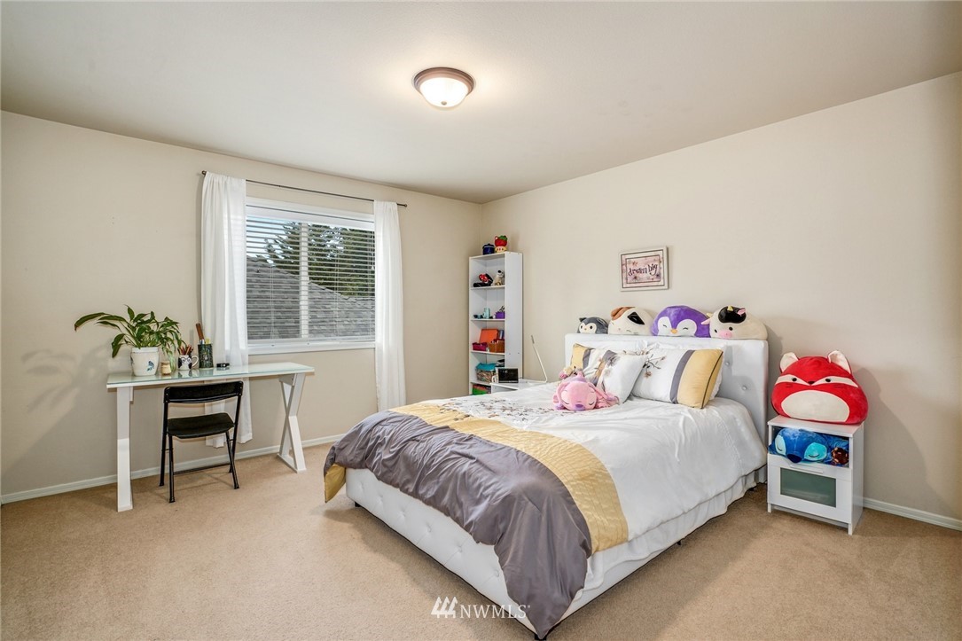 4113 Northeast 27th Place Renton, WA 98059 - Photo 20 of 27 a bedroom with a bed and a desk