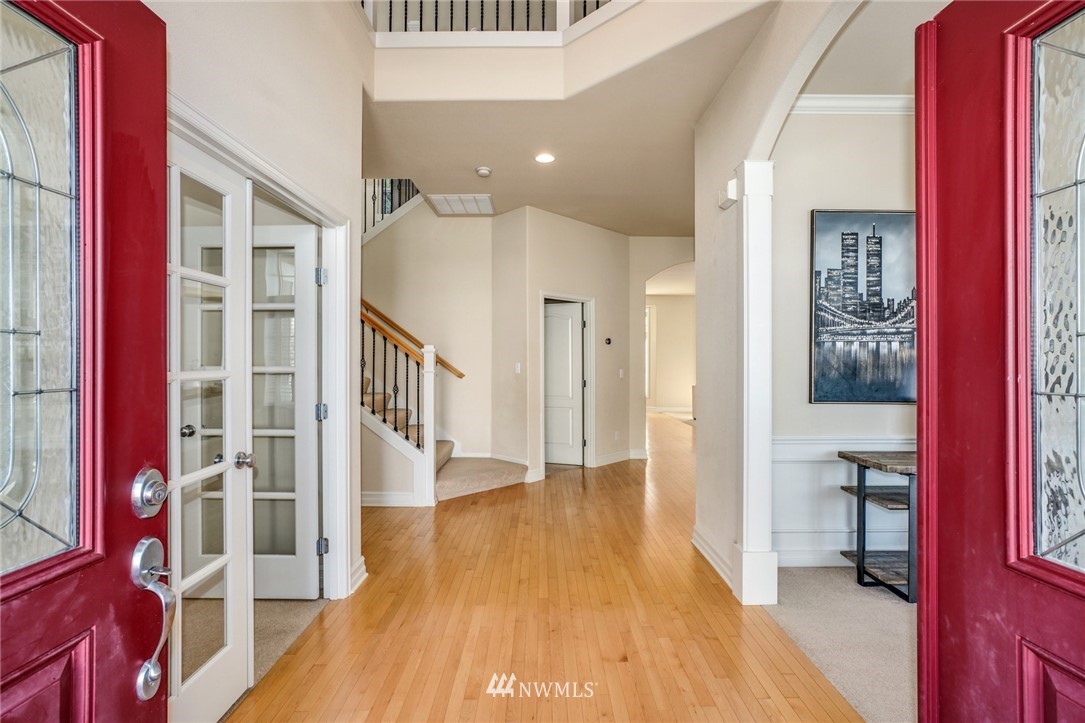 4113 Northeast 27th Place Renton, WA 98059 - Photo 3 of 27 a view of an entryway with wooden floor and a livingroom
