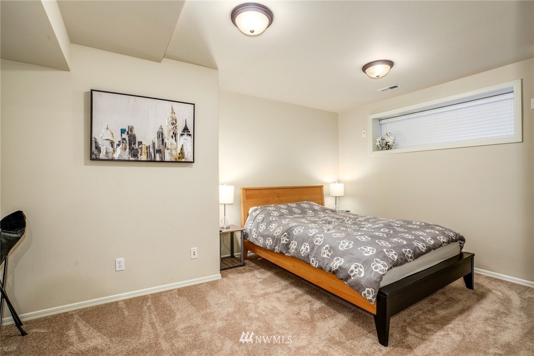 4113 Northeast 27th Place Renton, WA 98059 - Photo 22 of 27 a bedroom with a bed and wall painting