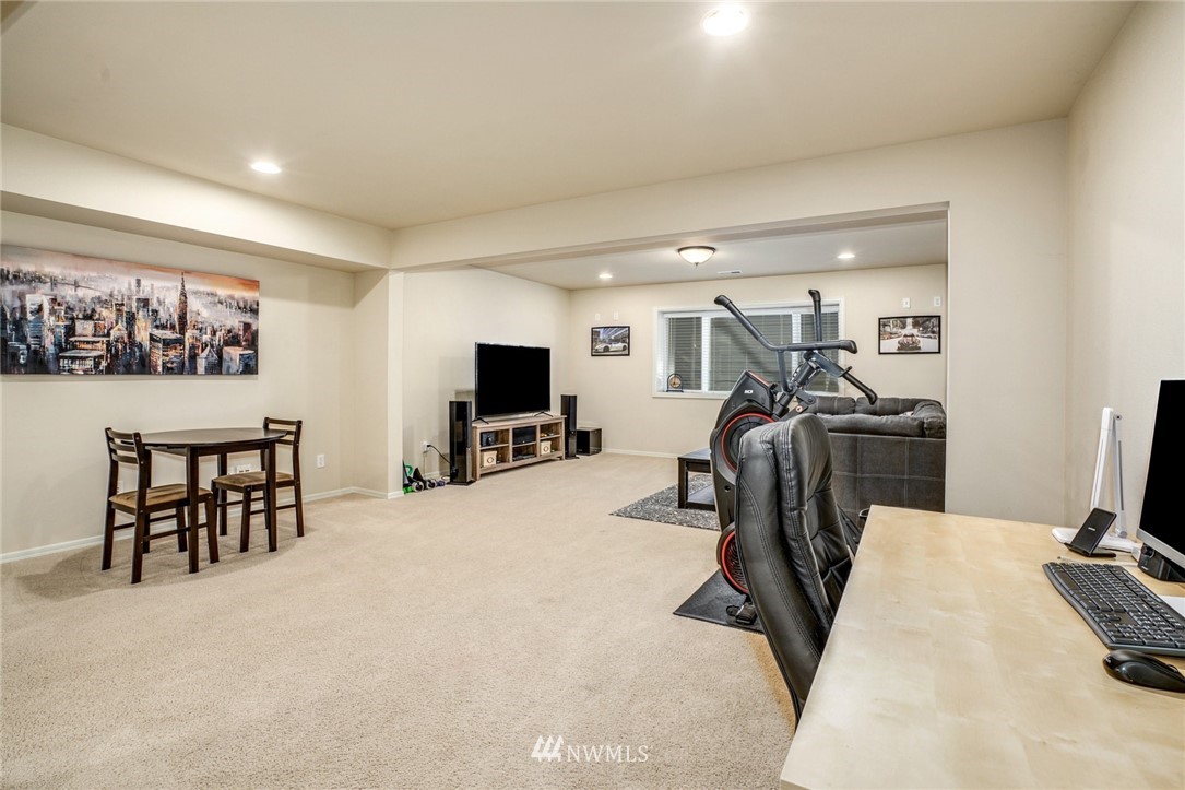 4113 Northeast 27th Place Renton, WA 98059 - Photo 23 of 27 a view of a livingroom with furniture and a flat screen tv
