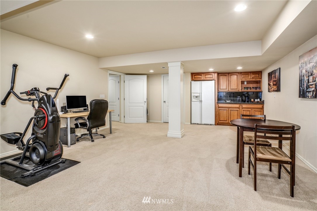 4113 Northeast 27th Place Renton, WA 98059 - Photo 24 of 27 a view of a livingroom with furniture and gym equipment