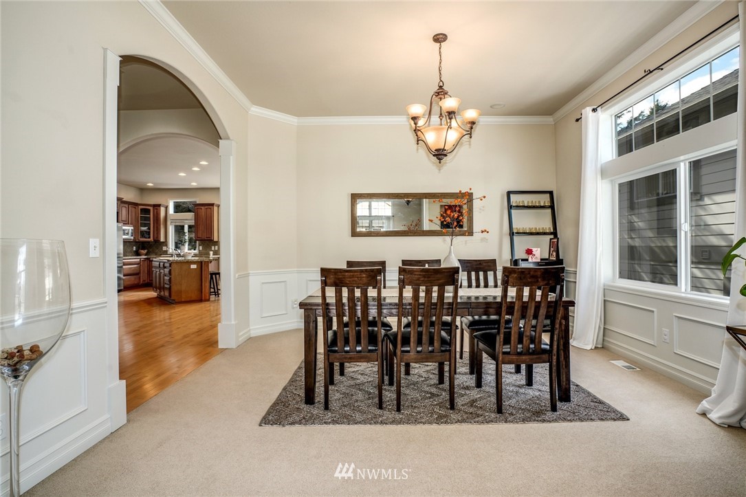 4113 Northeast 27th Place Renton, WA 98059 - Photo 9 of 27 a view of a dining room with furniture and chandelier