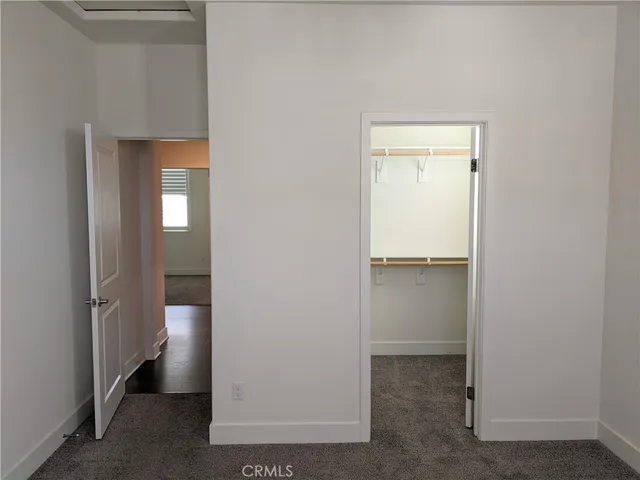 a view of a hallway with wooden shelves
