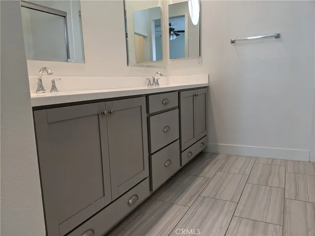 a bathroom with a double vanity sink and mirror