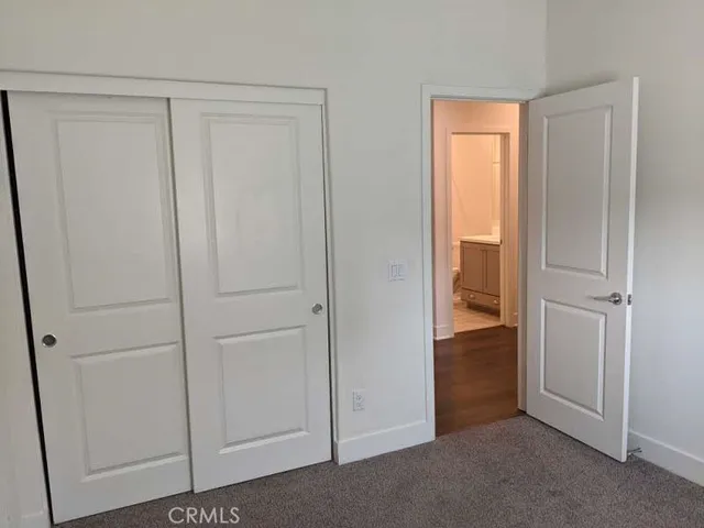 a view of an empty room and closet area