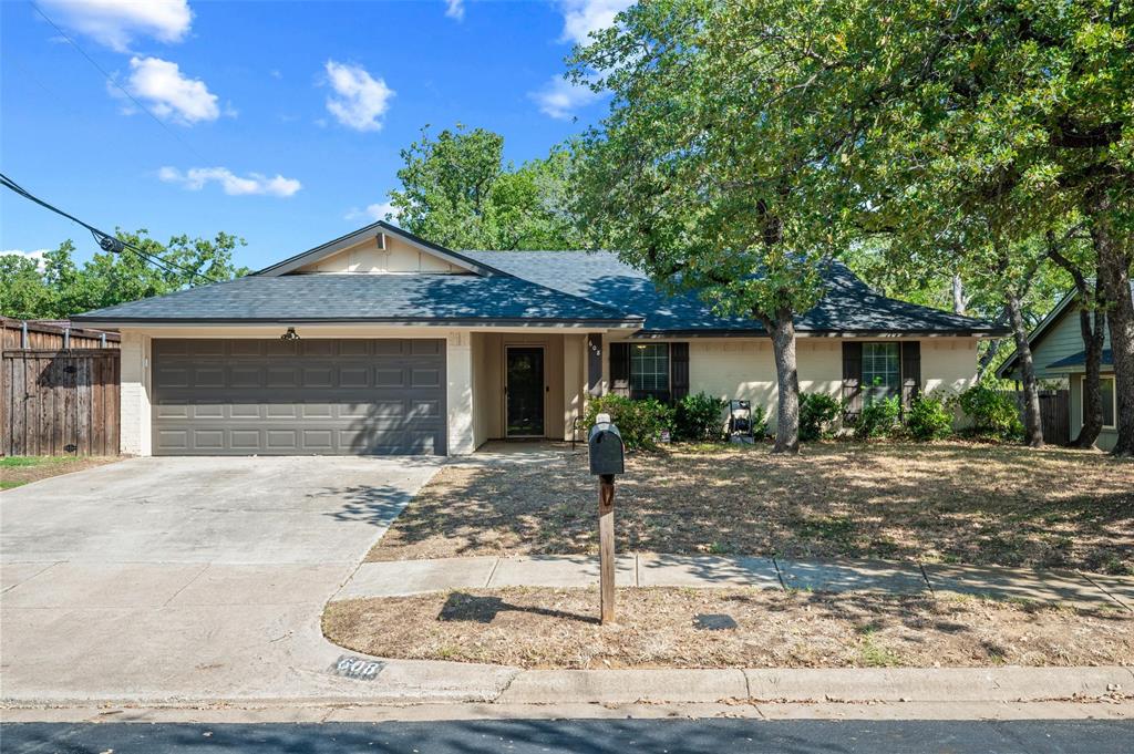 608 Ridgewood Circle Hurst, TX 76054 - Photo 2 of 38 Single-story residence featuring a two-car garage, concrete driveway, and mature landscaping