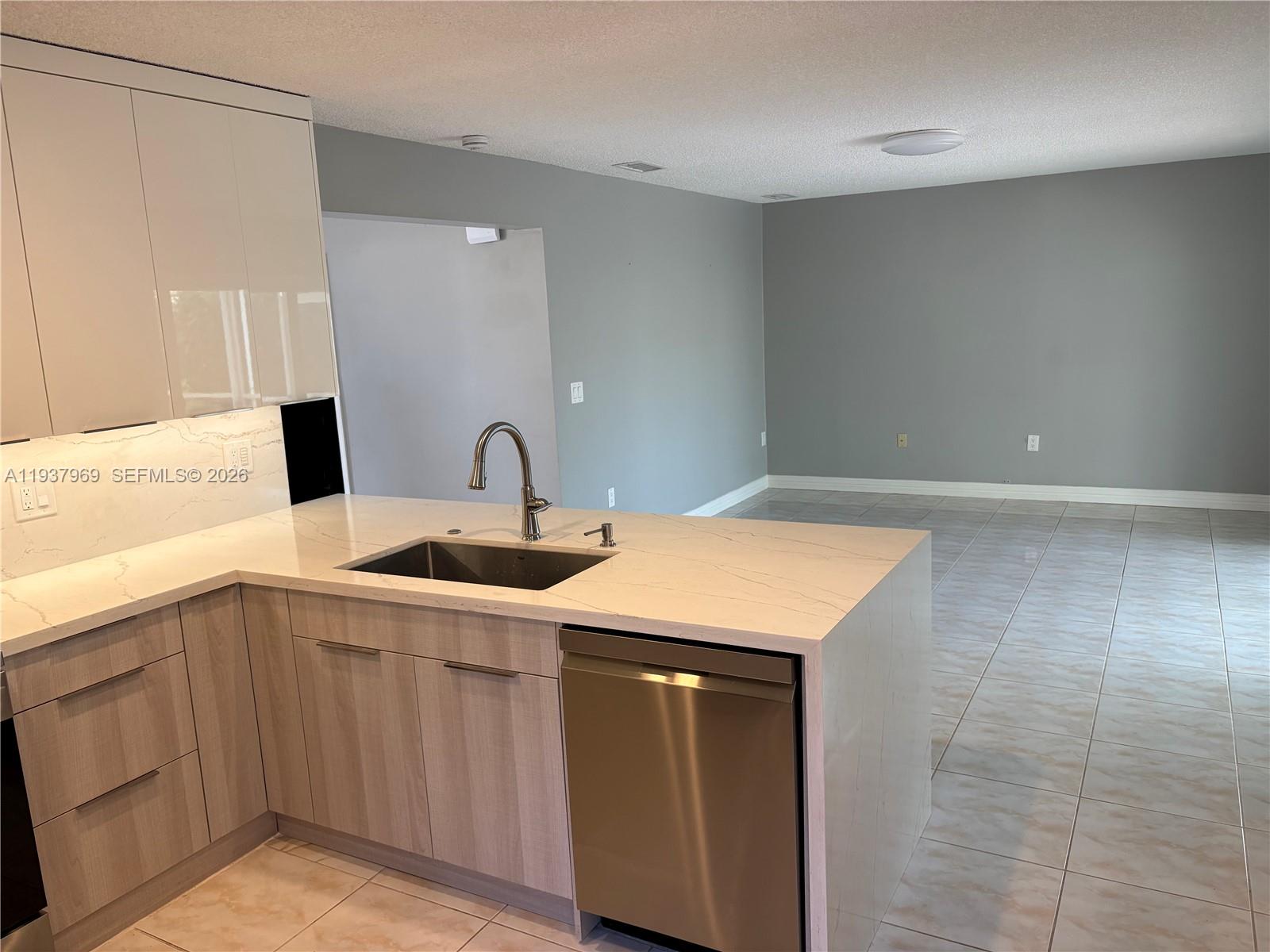 117 Danielle Court Weston, FL 33326 - Photo 11 of 43 a kitchen with a sink cabinets and wooden floor