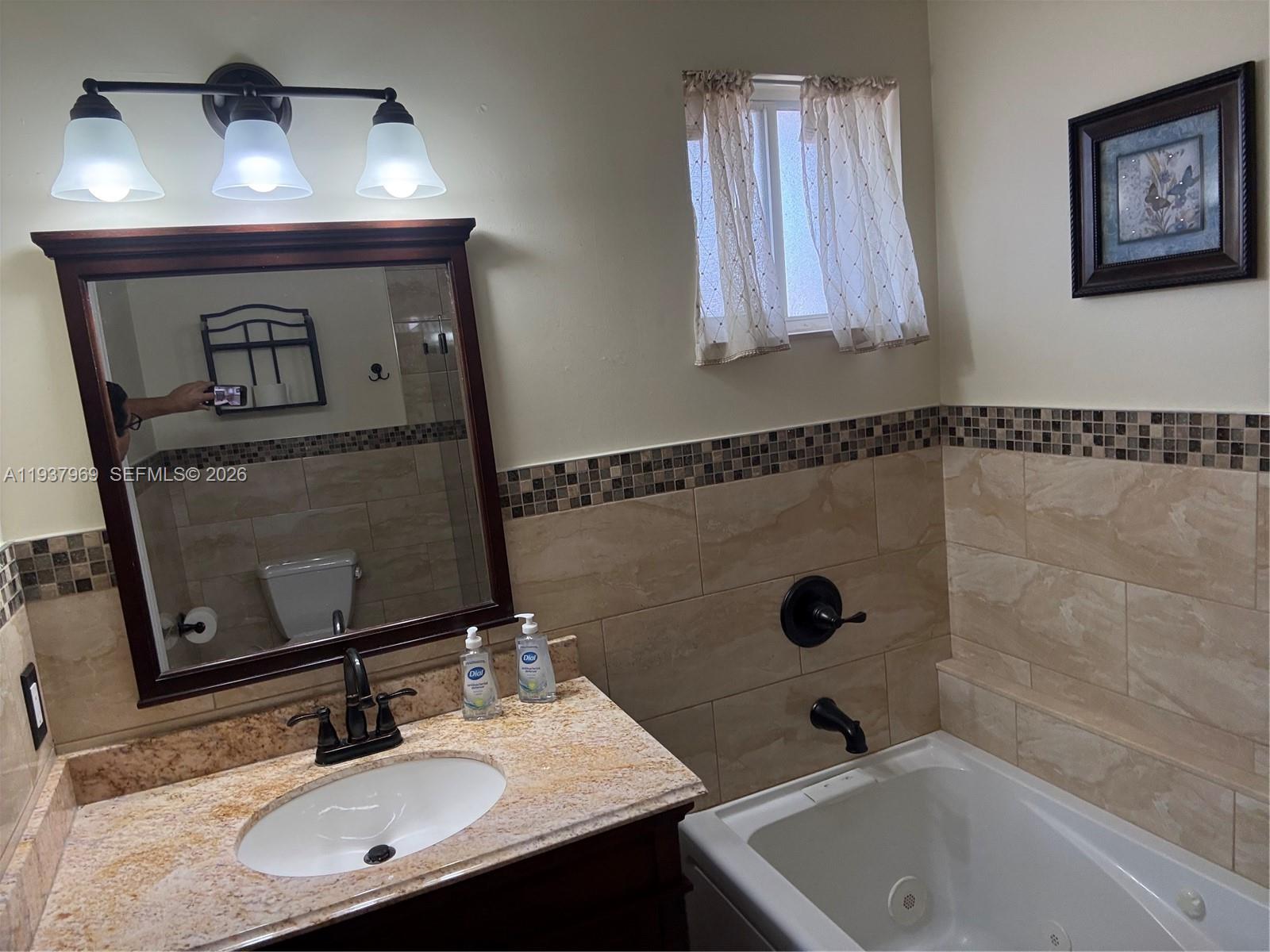 117 Danielle Court Weston, FL 33326 - Photo 16 of 43 a bathroom with a sink and a mirror