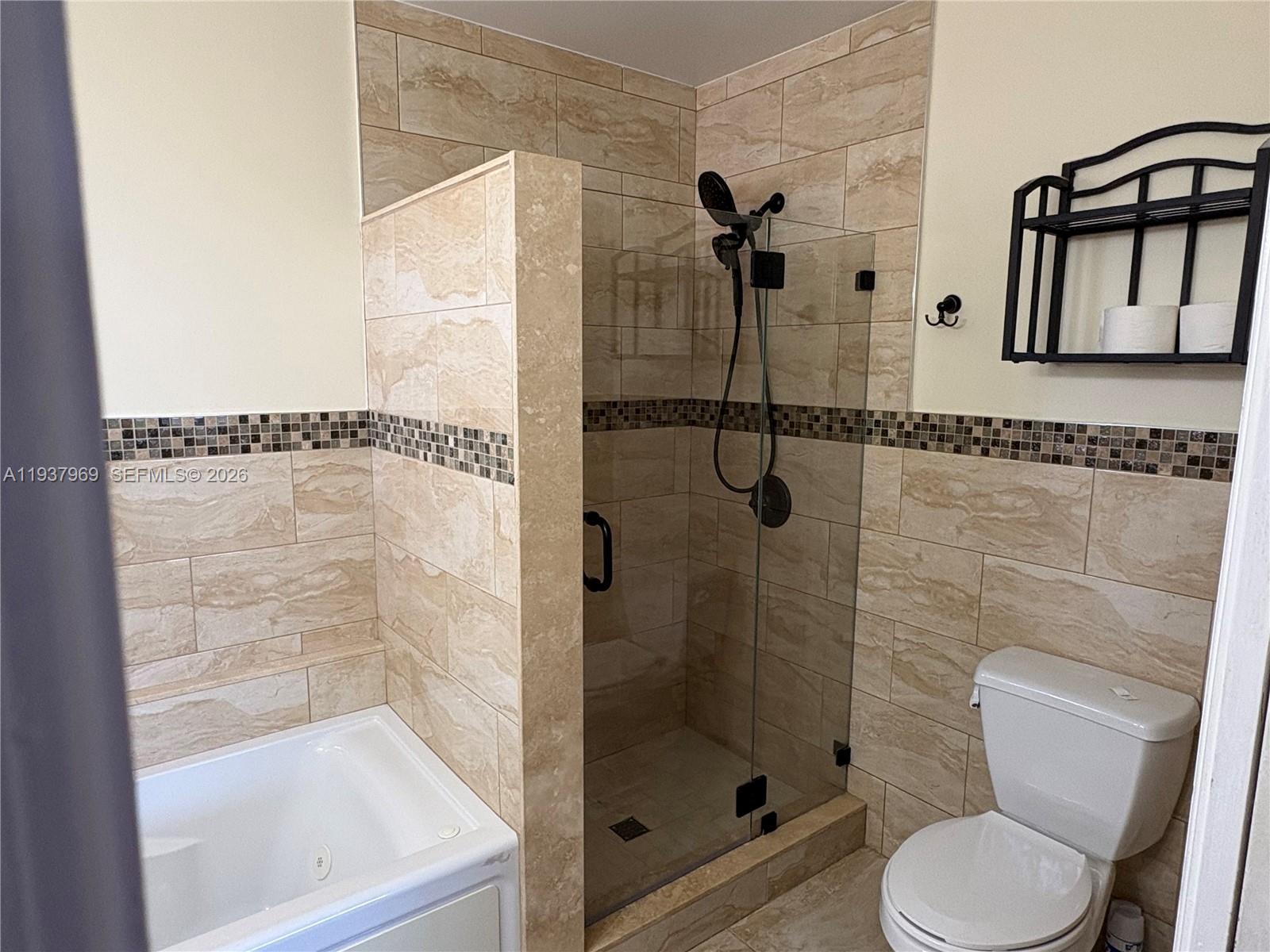 117 Danielle Court Weston, FL 33326 - Photo 17 of 43 a bathroom with a shower a toilet and a window