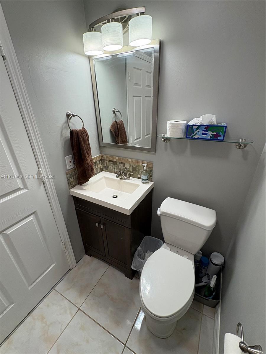117 Danielle Court Weston, FL 33326 - Photo 25 of 43 a bathroom with a toilet a sink and mirror