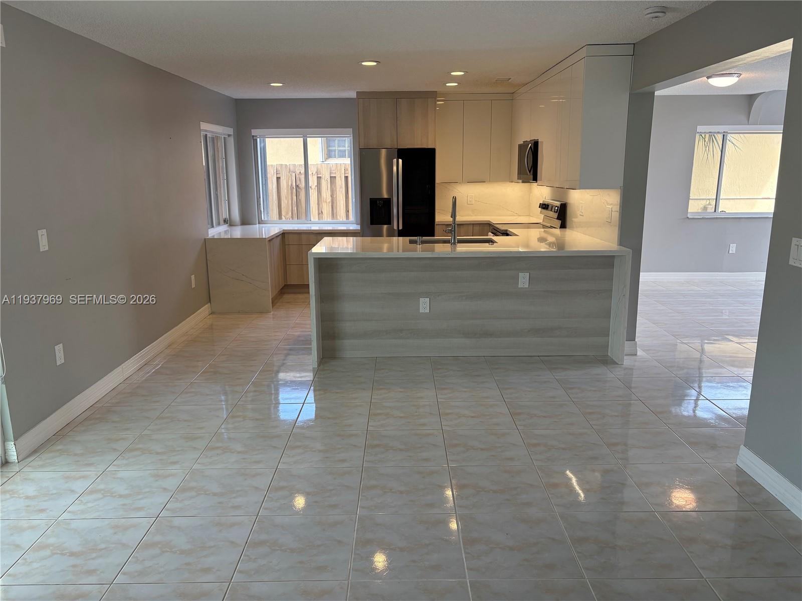 117 Danielle Court Weston, FL 33326 - Photo 6 of 43 a living room with granite countertop furniture and a fireplace