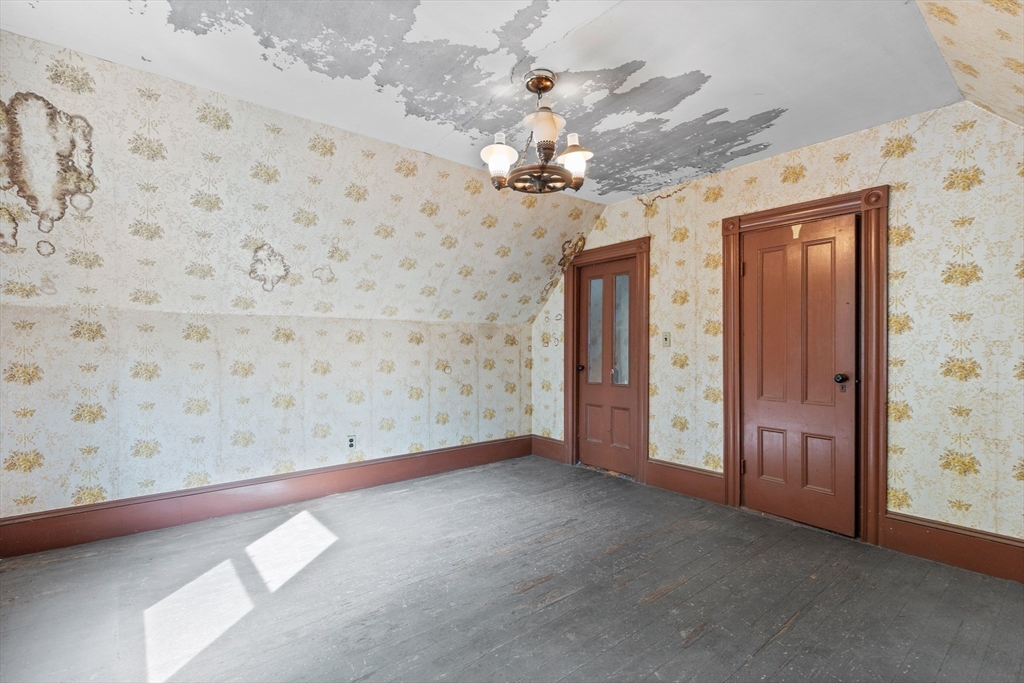 66 Round Hill Street Boston, MA 02130 - Photo 11 of 17 en empty room with windows