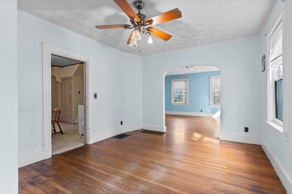 66 Round Hill Street Boston, MA 02130 - Photo 5 of 17 a view of an empty room with window and wooden floor