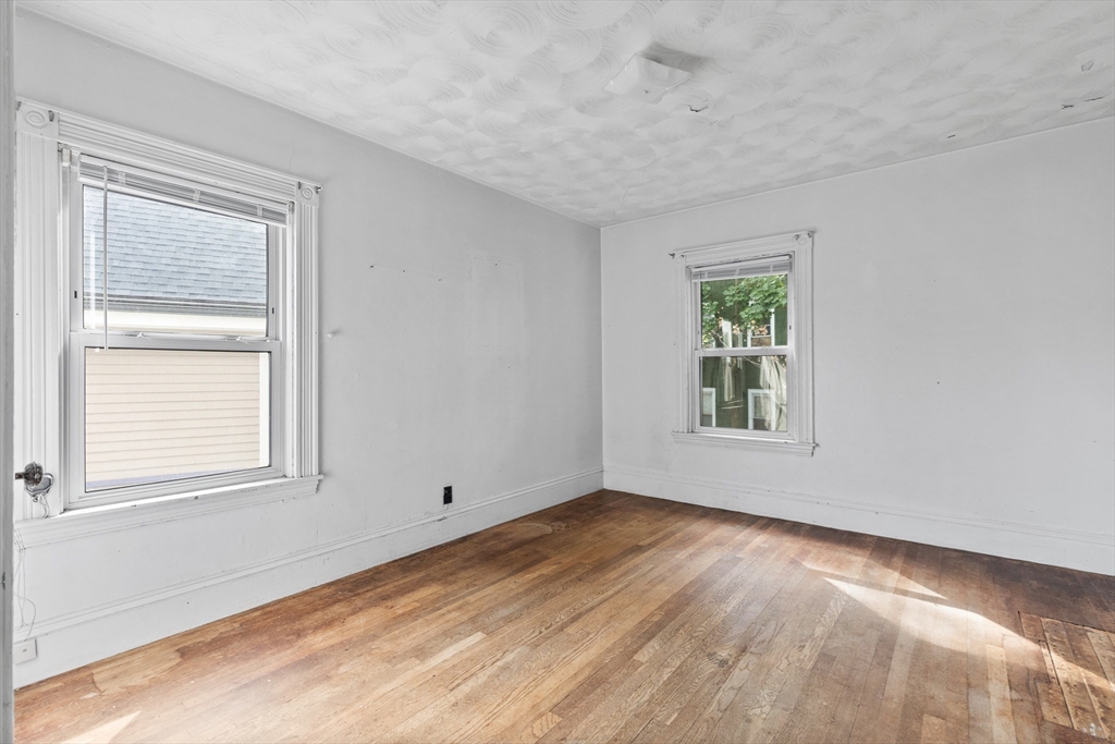 66 Round Hill Street Boston, MA 02130 - Photo 9 of 17 an empty room with a window