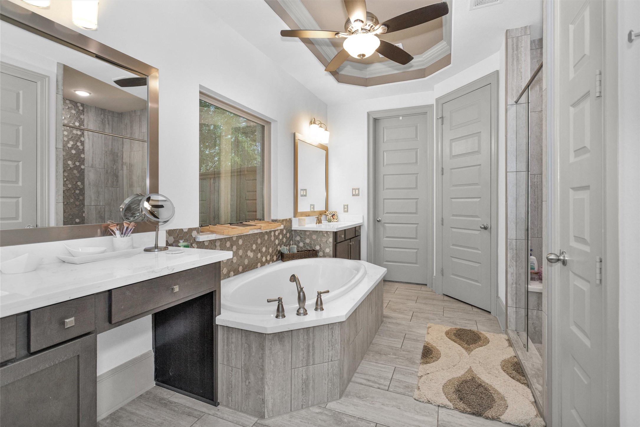 106 Cliftons Curve Way Montgomery, TX 77316 - Photo 26 of 47 This bathroom features a luxurious soaking tub, dual vanities w/ample counter space, a large walk-in shower, custom painted doors, and elegant flooring.