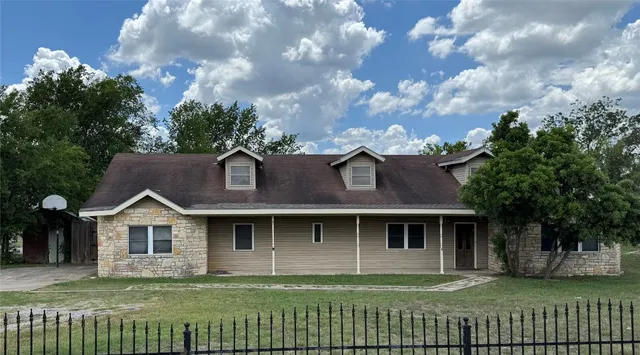 a front view of a house with a garden