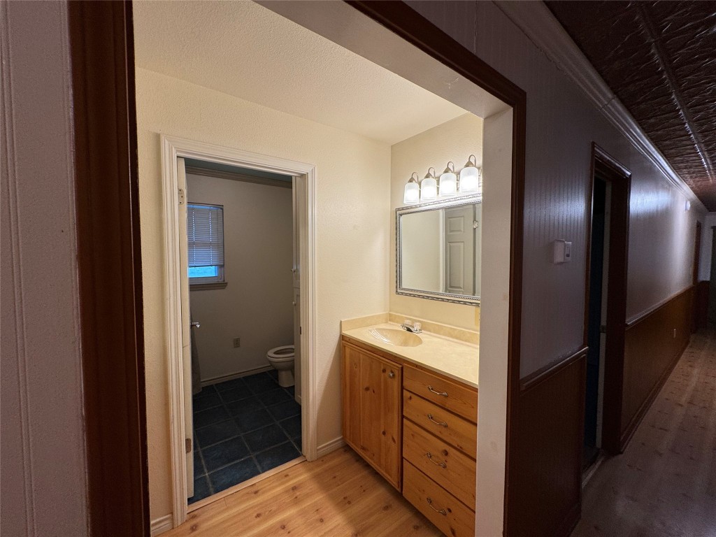 5054 Old Goforth Road Buda, TX 78610 - Photo 12 of 28 a bathroom with a double vanity sink and mirror with shower