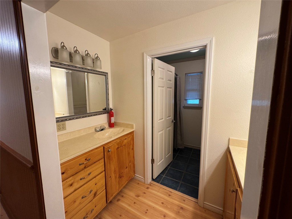 5054 Old Goforth Road Buda, TX 78610 - Photo 13 of 28 a kitchen with a refrigerator sink and mirror